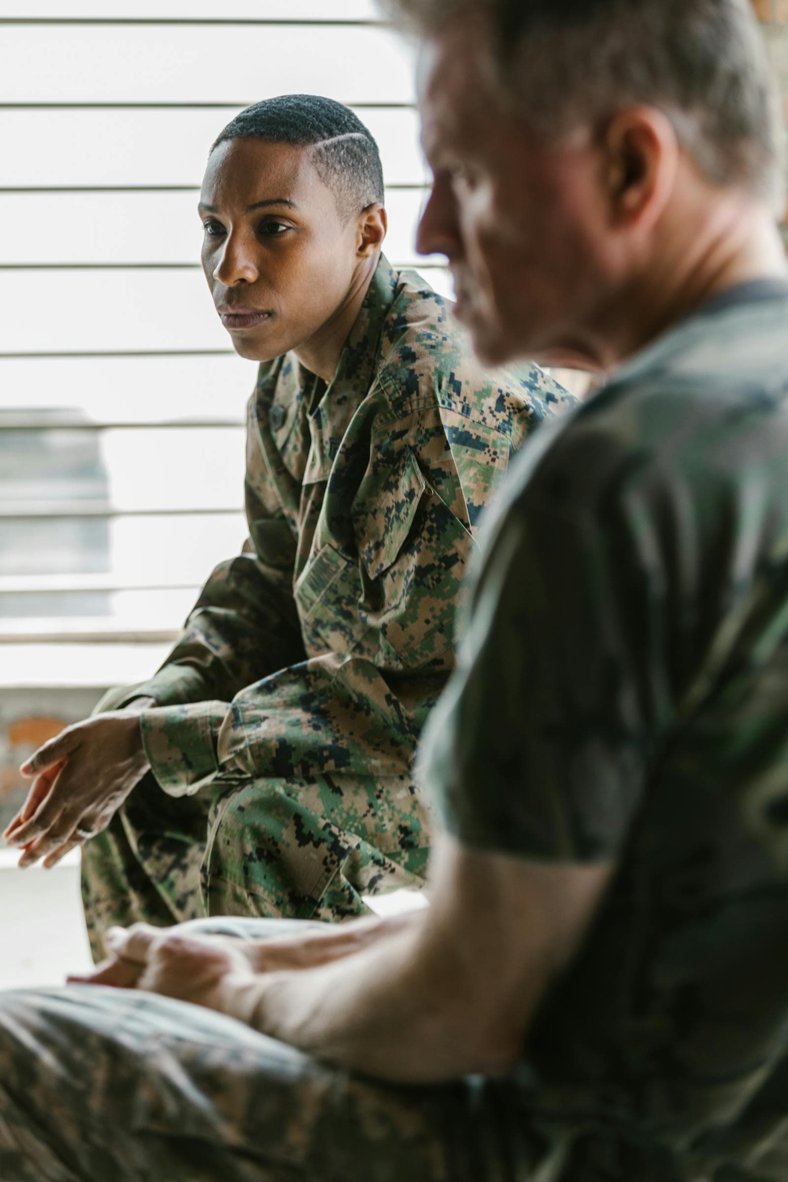 Military veterans in a supportive group discussion, a setting families often need to navigate alongside VA home care.